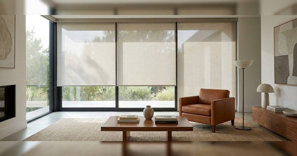 A living room as the blinds open to let daylight in